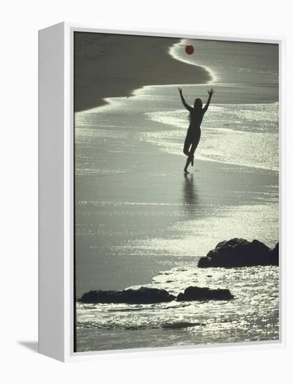 Young Woman in Silhouette Running Along Beach at Twilight Throwing Beach Ball Up in the Air-Co Rentmeester-Framed Premier Image Canvas