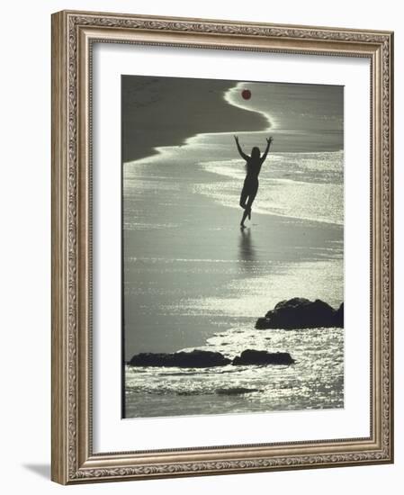 Young Woman in Silhouette Running Along Beach at Twilight Throwing Beach Ball Up in the Air-Co Rentmeester-Framed Photographic Print