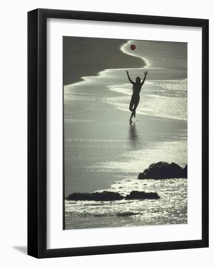 Young Woman in Silhouette Running Along Beach at Twilight Throwing Beach Ball Up in the Air-Co Rentmeester-Framed Photographic Print