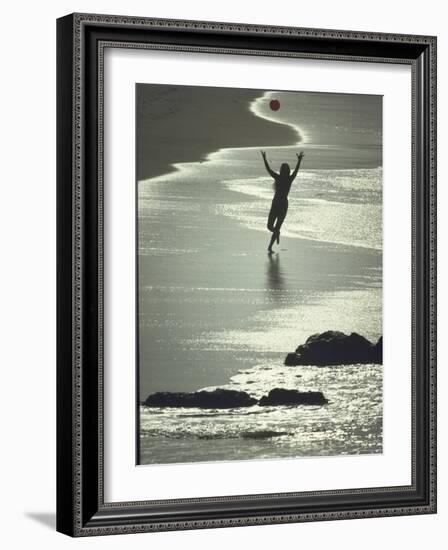 Young Woman in Silhouette Running Along Beach at Twilight Throwing Beach Ball Up in the Air-Co Rentmeester-Framed Photographic Print