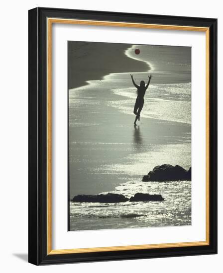 Young Woman in Silhouette Running Along Beach at Twilight Throwing Beach Ball Up in the Air-Co Rentmeester-Framed Photographic Print