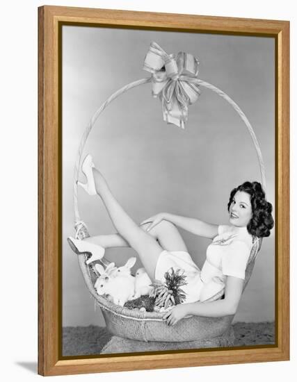 Young Woman, Looking Like a Present, Sitting in Gift Basket with Bunnies-null-Framed Stretched Canvas