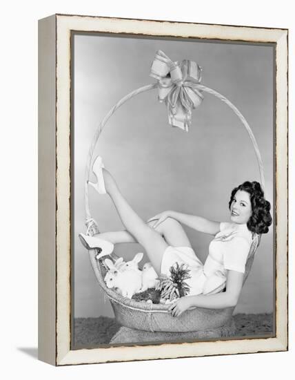 Young Woman, Looking Like a Present, Sitting in Gift Basket with Bunnies-null-Framed Stretched Canvas