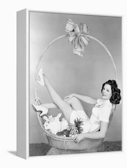 Young Woman, Looking Like a Present, Sitting in Gift Basket with Bunnies-null-Framed Stretched Canvas