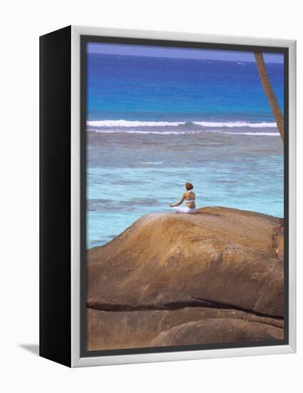 Young Woman Meditating on Rock, Seychelles, Indian Ocean, Africa-Sakis Papadopoulos-Framed Premier Image Canvas