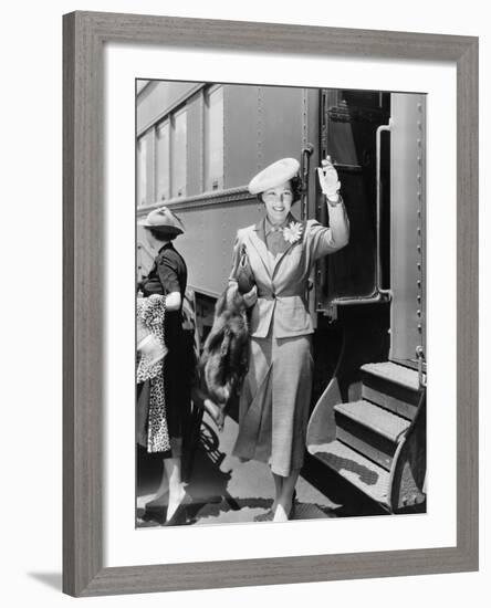 Young Woman Next to Train Waving-null-Framed Photo