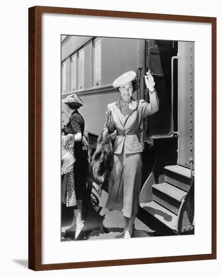 Young Woman Next to Train Waving-null-Framed Photo