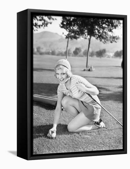 Young Woman on a Golf Course Placing a Golf Ball-null-Framed Stretched Canvas