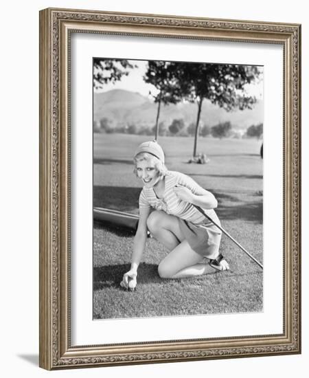 Young Woman on a Golf Course Placing a Golf Ball-null-Framed Photo