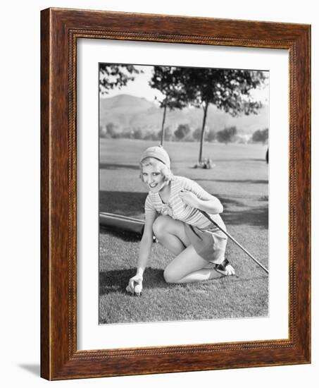 Young Woman on a Golf Course Placing a Golf Ball-null-Framed Photo