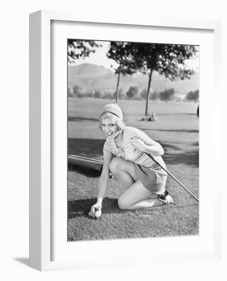 Young Woman on a Golf Course Placing a Golf Ball-null-Framed Photo