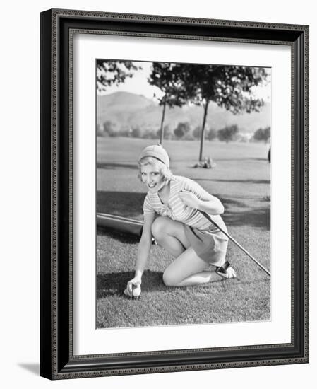 Young Woman on a Golf Course Placing a Golf Ball-null-Framed Photo