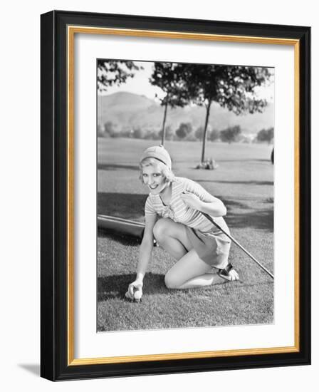 Young Woman on a Golf Course Placing a Golf Ball-null-Framed Photo