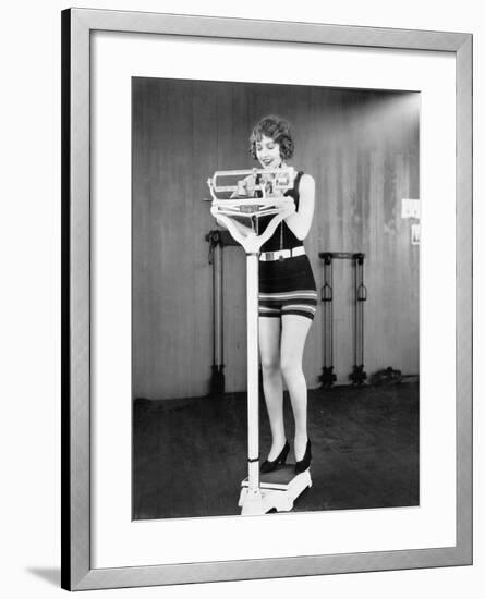 Young Woman on a Scale Taking Her Weight-null-Framed Photo