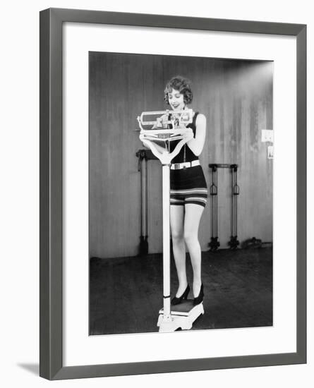 Young Woman on a Scale Taking Her Weight-null-Framed Photo