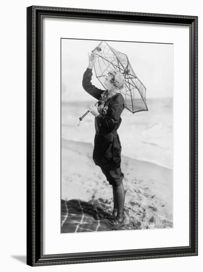 Young Woman on the Beach with an Umbrella Looking Like a Spider Web-null-Framed Photo