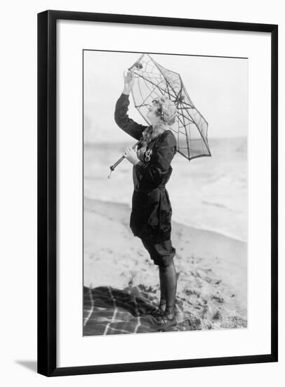 Young Woman on the Beach with an Umbrella Looking Like a Spider Web-null-Framed Photo