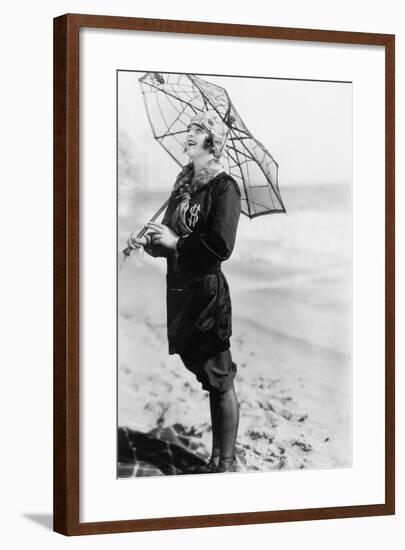 Young Woman on the Beach with an Umbrella Looking Like a Spider Web-null-Framed Photo