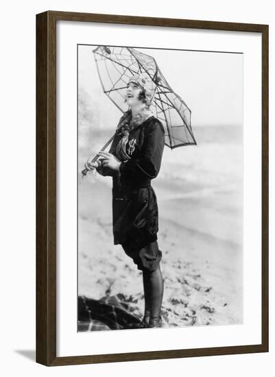 Young Woman on the Beach with an Umbrella Looking Like a Spider Web-null-Framed Photo