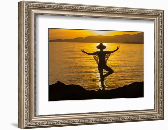 Young woman performs yoga posture against setting sun-Charles Bowman-Framed Photographic Print