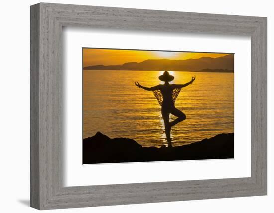 Young woman performs yoga posture against setting sun-Charles Bowman-Framed Photographic Print