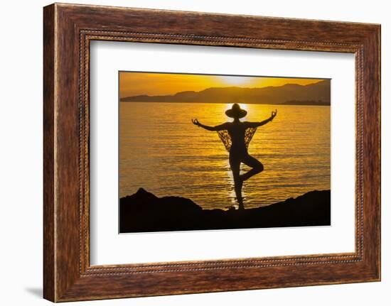 Young woman performs yoga posture against setting sun-Charles Bowman-Framed Photographic Print