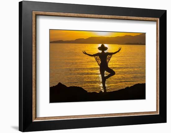 Young woman performs yoga posture against setting sun-Charles Bowman-Framed Photographic Print