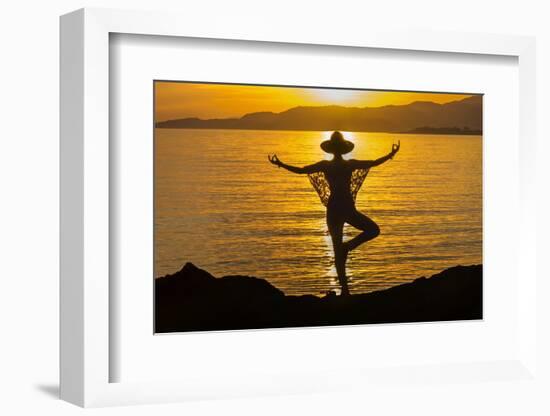 Young woman performs yoga posture against setting sun-Charles Bowman-Framed Photographic Print