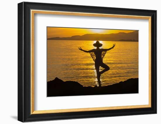 Young woman performs yoga posture against setting sun-Charles Bowman-Framed Photographic Print