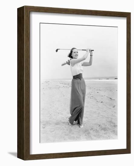 Young Woman Playing Golf at the Beach-null-Framed Photo