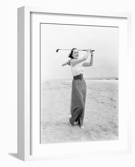 Young Woman Playing Golf at the Beach-null-Framed Photo