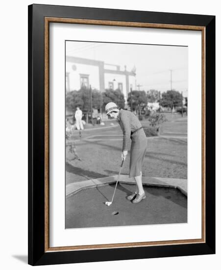 Young Woman Playing Mini Golf-null-Framed Photo