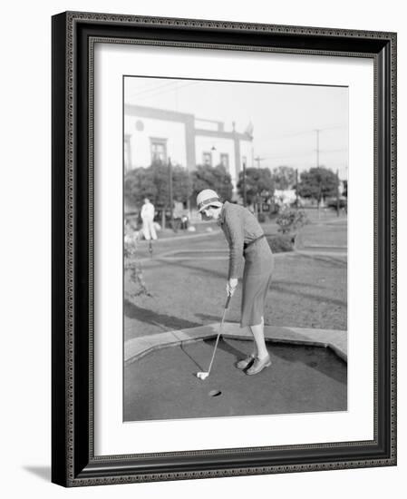 Young Woman Playing Mini Golf-null-Framed Photo