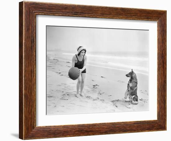 Young Woman Playing with Her Dog and Ball on the Beach-null-Framed Photo