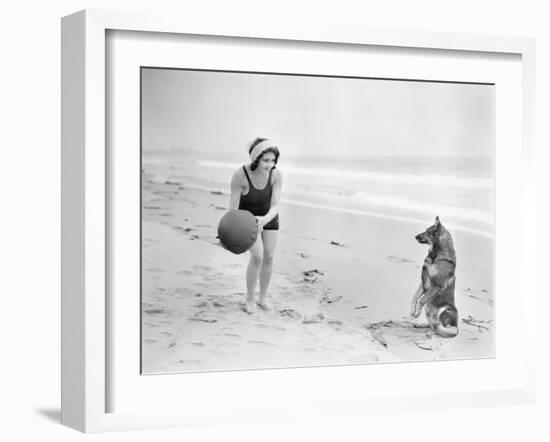 Young Woman Playing with Her Dog and Ball on the Beach-null-Framed Photo