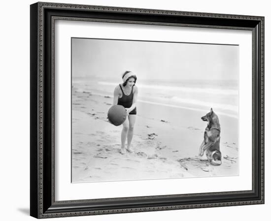 Young Woman Playing with Her Dog and Ball on the Beach-null-Framed Photo