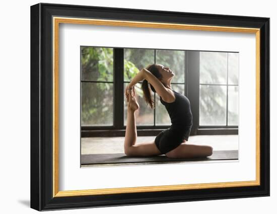 Young Woman Practicing Yoga, Stretching in One Legged King Pigeon Exercise, Eka Pada Rajakapotasana-fizkes-Framed Photographic Print