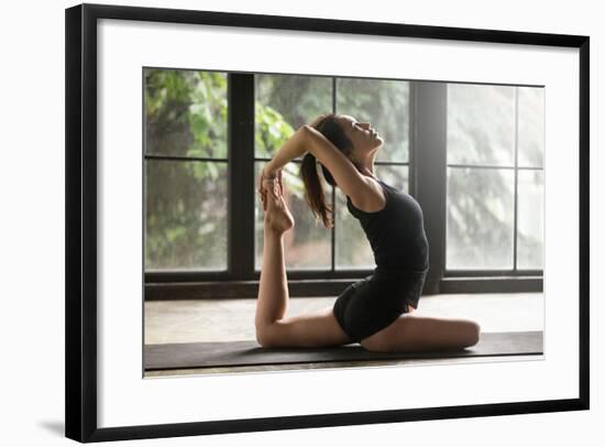 Young Woman Practicing Yoga, Stretching in One Legged King Pigeon Exercise, Eka Pada Rajakapotasana-fizkes-Framed Photographic Print