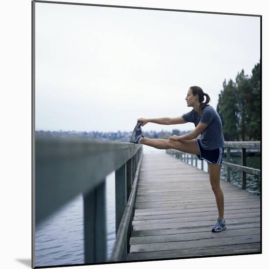 Young Woman Prepares for Jogging-Aaron McCoy-Mounted Photographic Print