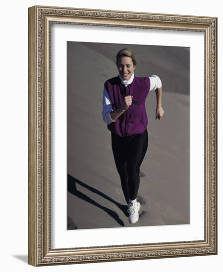 Young Woman Running Up a Sand Dune-null-Framed Photographic Print