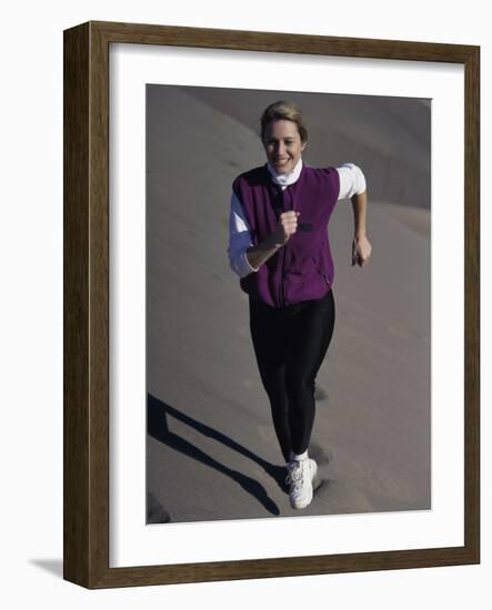 Young Woman Running Up a Sand Dune-null-Framed Photographic Print