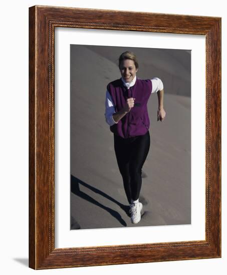 Young Woman Running Up a Sand Dune-null-Framed Photographic Print