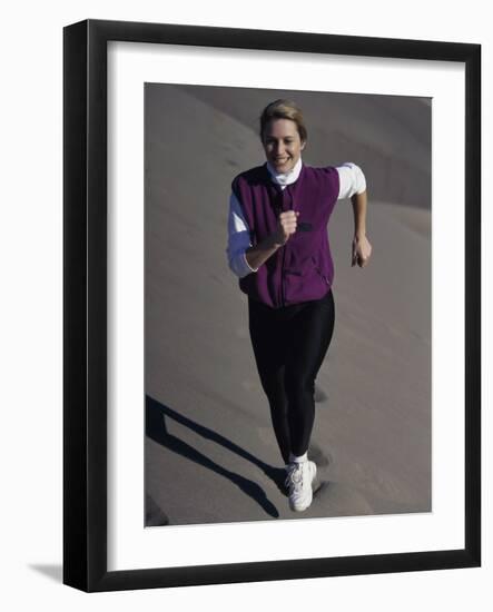 Young Woman Running Up a Sand Dune-null-Framed Photographic Print