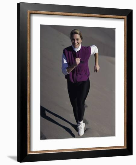 Young Woman Running Up a Sand Dune-null-Framed Photographic Print