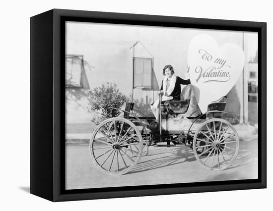 Young Woman Sitting on a Car Holding a Big Heart Shaped Sign-null-Framed Stretched Canvas