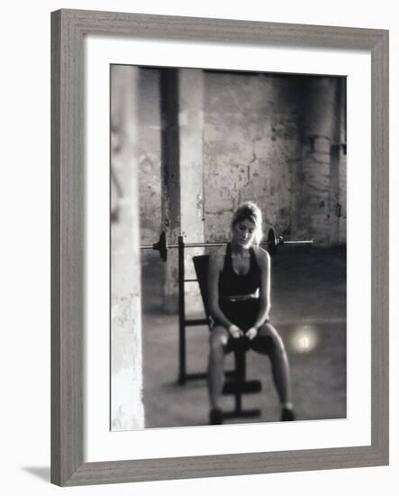 Young Woman Sitting on a Weight Bench-null-Framed Photographic Print