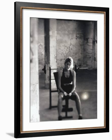 Young Woman Sitting on a Weight Bench-null-Framed Photographic Print