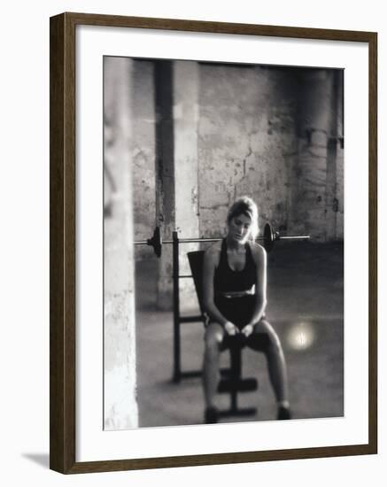 Young Woman Sitting on a Weight Bench-null-Framed Photographic Print