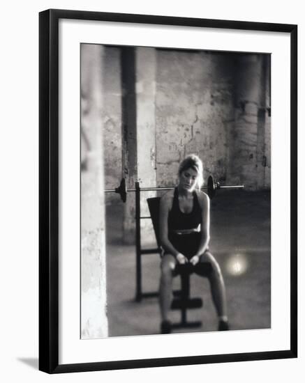 Young Woman Sitting on a Weight Bench-null-Framed Photographic Print