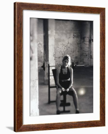 Young Woman Sitting on a Weight Bench-null-Framed Photographic Print